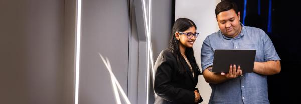 Two students collaborating with a laptop at UTS