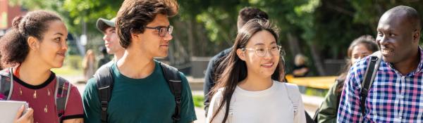 Four students walking together, chatting