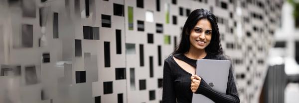 Woman stands in front of UTS building 11