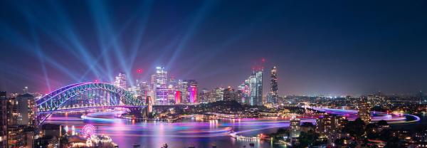 Sydney Harbour with Harbour Bridge illuminated in lights at night