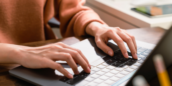 Student typing on computer