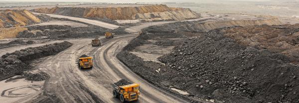 Large quarry dump truck. Big yellow mining truck at work site.