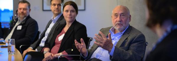 Picture of Professor Stiglitz hosting discussion at boardroom table