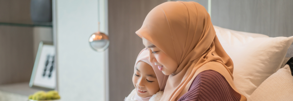 Muslim mother and daughter looking at a tablet