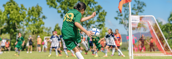 Girl kicking a soccer ball