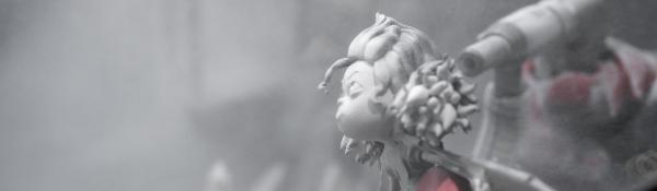 Close up of a 3D printed animated character being bead blasted