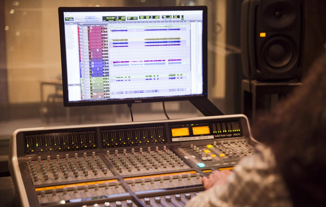 A sound mixing board with Pro Tools running