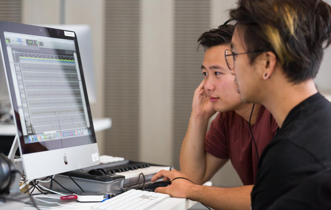 Two students looking at a computer