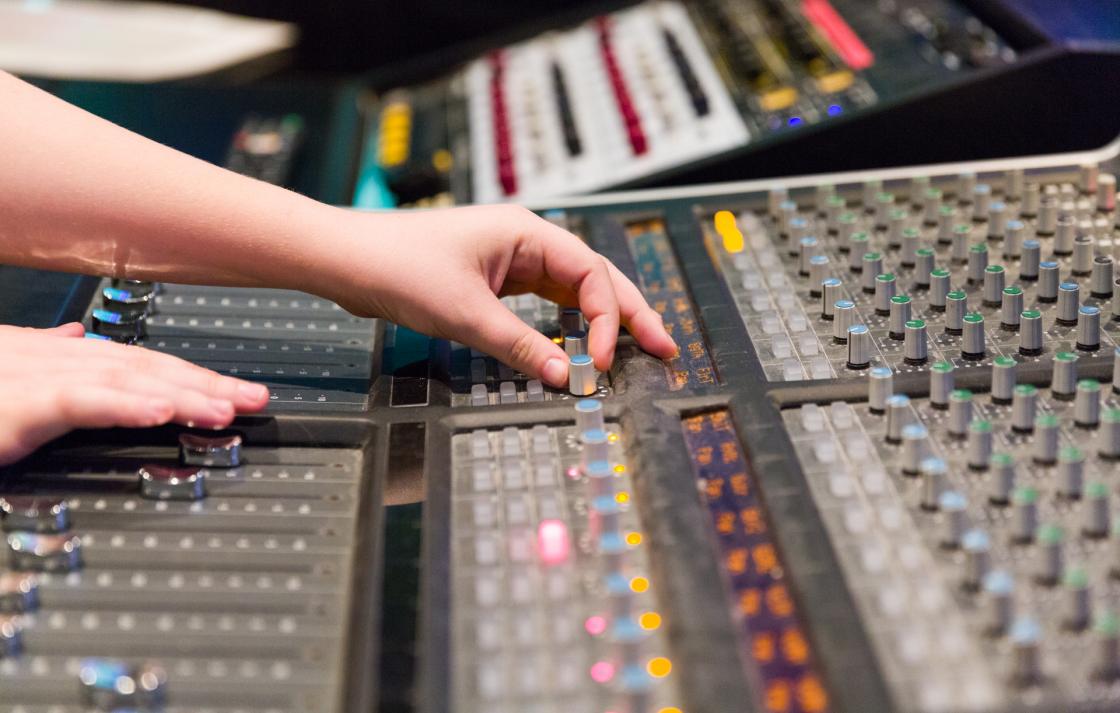 Student using a sound mixing console