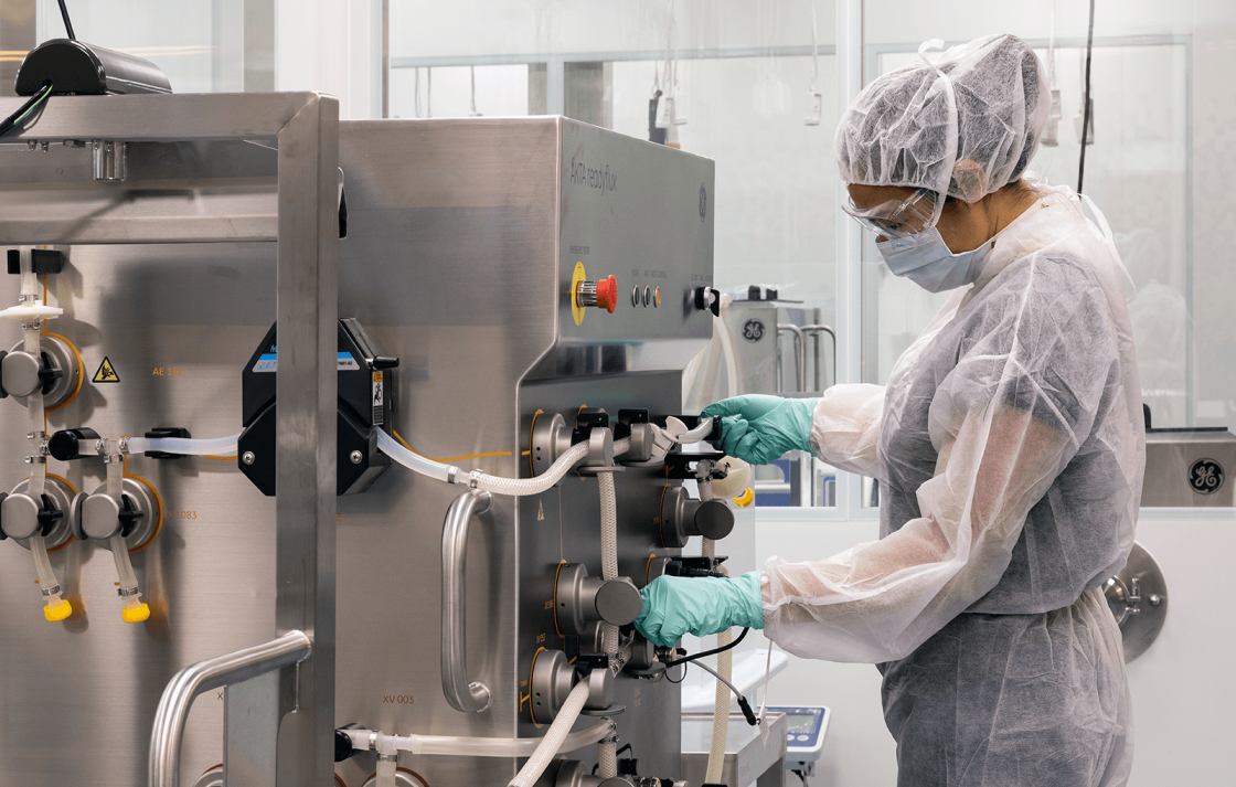 Researcher working with equipment in the Biologics Innovation Facility