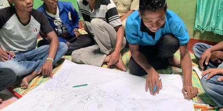 Group of men collaborating over a map