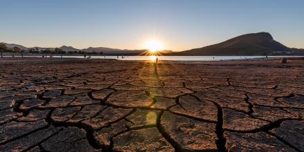 Dry ground with a low pond in the distance