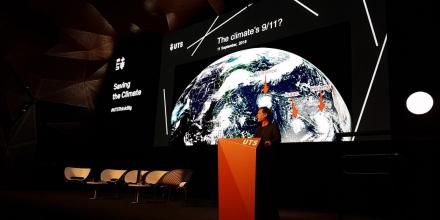 Stage with screen showing world globe