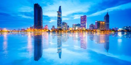 Reflection of Night view of Business District and Administrative Center of Ho Chi Minh city on Saigon riverbank. 