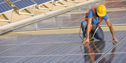 Worker positioning solar panels