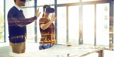 Two people wearing virtual reality goggles