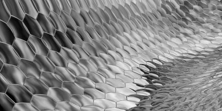 Greyscale geometric hexagonal pattern curving into the distance