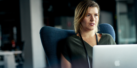 Woman sitting in front of laptop