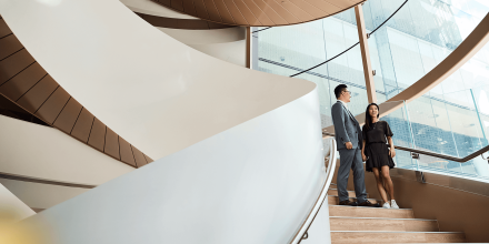 Two students walking down the spiral stairs inside UTS building 2