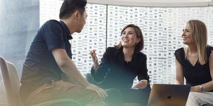 Three UTS students sitting and having a discussion