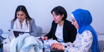 Three students working as part of the UTS Social Impact Hackathon.