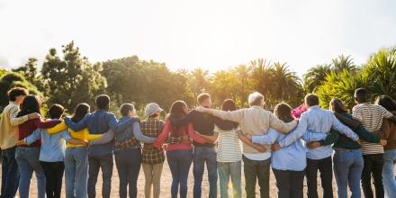 A line-up of people with their arms around each other