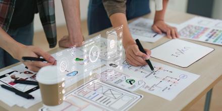 Close up ux developer and ui designer brainstorming interface wireframe design