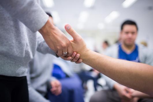 Physiotherapy student practicing therapy on hand