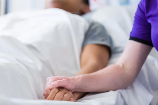 UTS nurse holding a patients hand