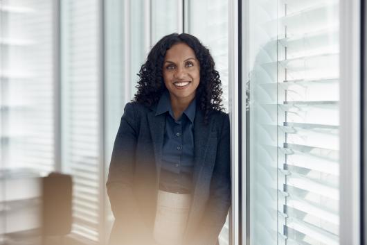 a woman stands in an office