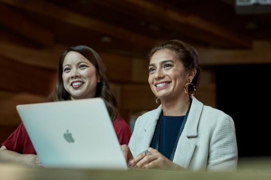 Two female postgrad students working on a laptop