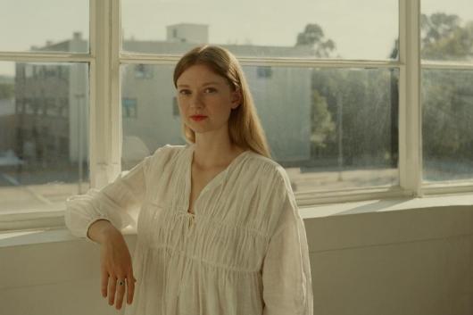 image of girl standing by a window