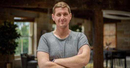 Amir Tukic, Data Science Engineering student, stands smiling, with arms folded