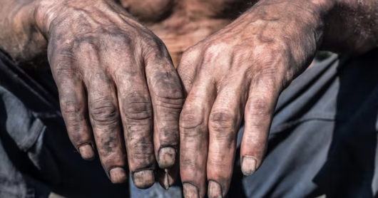 a worker's hands, dirty with coal dust