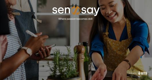 a woman smiles while she attends a sensay class.