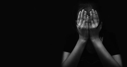 A girl holds her head in her hands