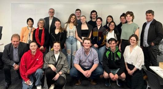 Group photo of year 11 students and university academics taken in classroom.