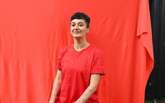 a woman dressed in red smiles at the camera