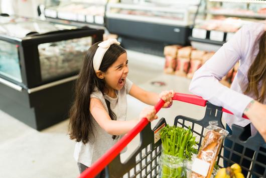 Stock picture of a young girl throwing a tantrum in a supermarket