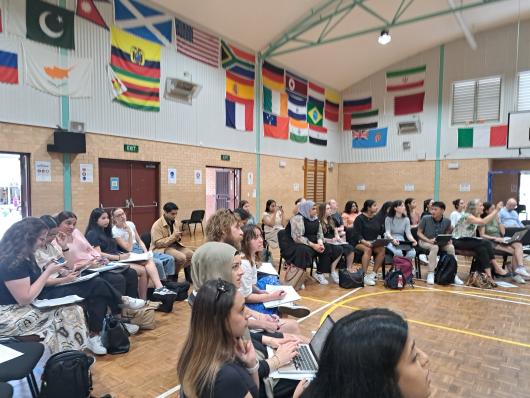 Over 30 UTS teacher education students seated inside a high school gym