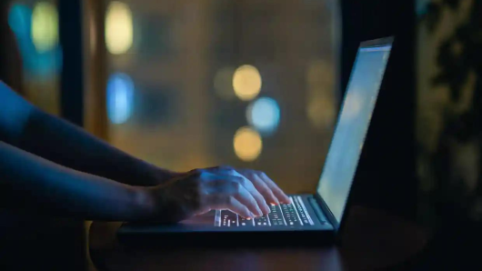 hands typing on a laptop
