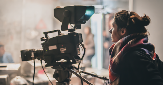 A woman controls a film camera on set