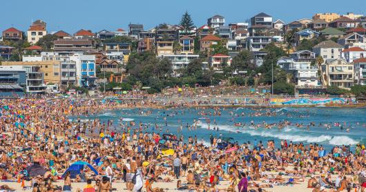 Very crowded but immensely popular Bondi Beach in Sydney. Thousands of sun lovers will gather here to swim and surf on any sunny day, tourists and locals alike.