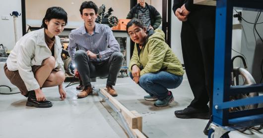 UTS robotics students observe a 'soft robot' grow and navigate a tube during a demonstration for NBN representatives.