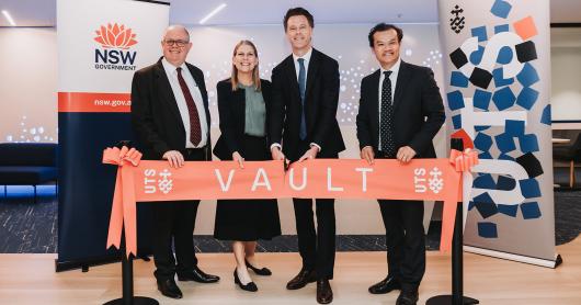 The Vice Chancellor, Dean of the Faculty of Engineering and IT, NSW Premier and fellow government Minister pose with a red ribbon that says 'vault'