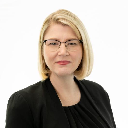 Myfanwy Wallwork - Blonde short hair, black glasses and black top 
