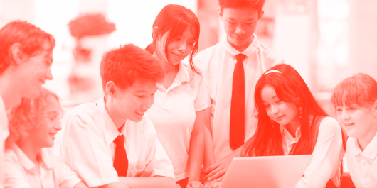 A group of school students looking at a computer screen.