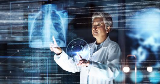 A doctor examines a lung xray in a hologram setting surrounded by images of data.