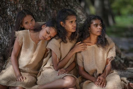 A group of young Indigenous women wearing a "punishment dress" design. Djunngaal Elders Group Yarrbah Collection, Punishment Dress, curated by Simone Arnol and Bernard Lee Singleton for CIAF 2019. Wade Lewis