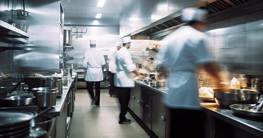 Commercial kitchen with chefs working. Adobe Stock 